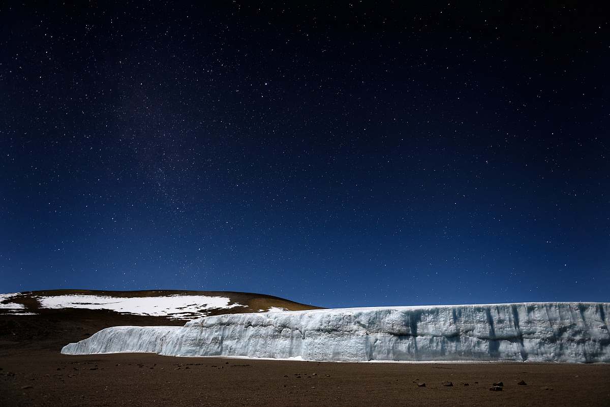 mount kilimanjaro white and brown mountain under starry night tanzania